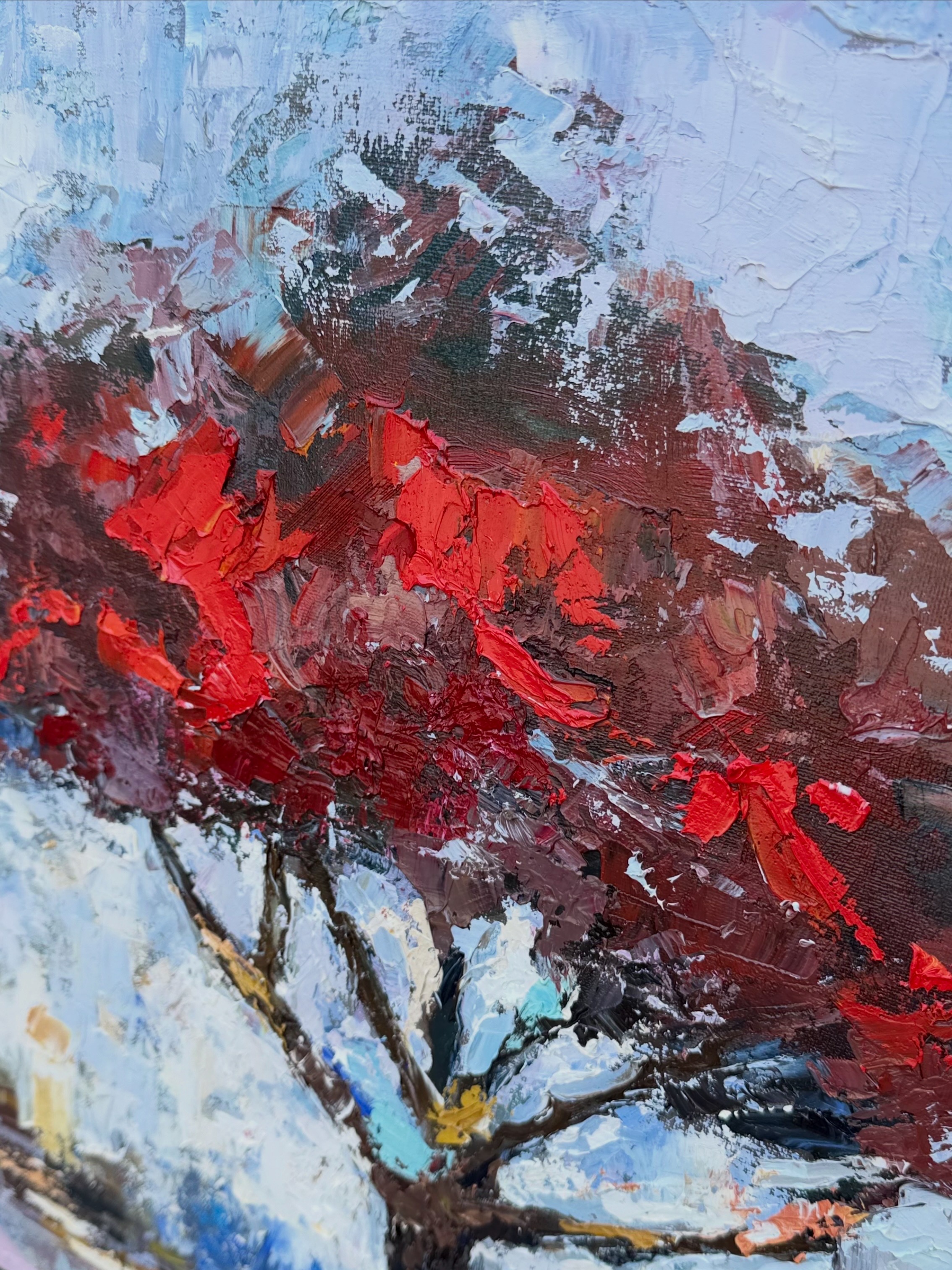 Macro detail of thick red, blue and umber brushstrokes