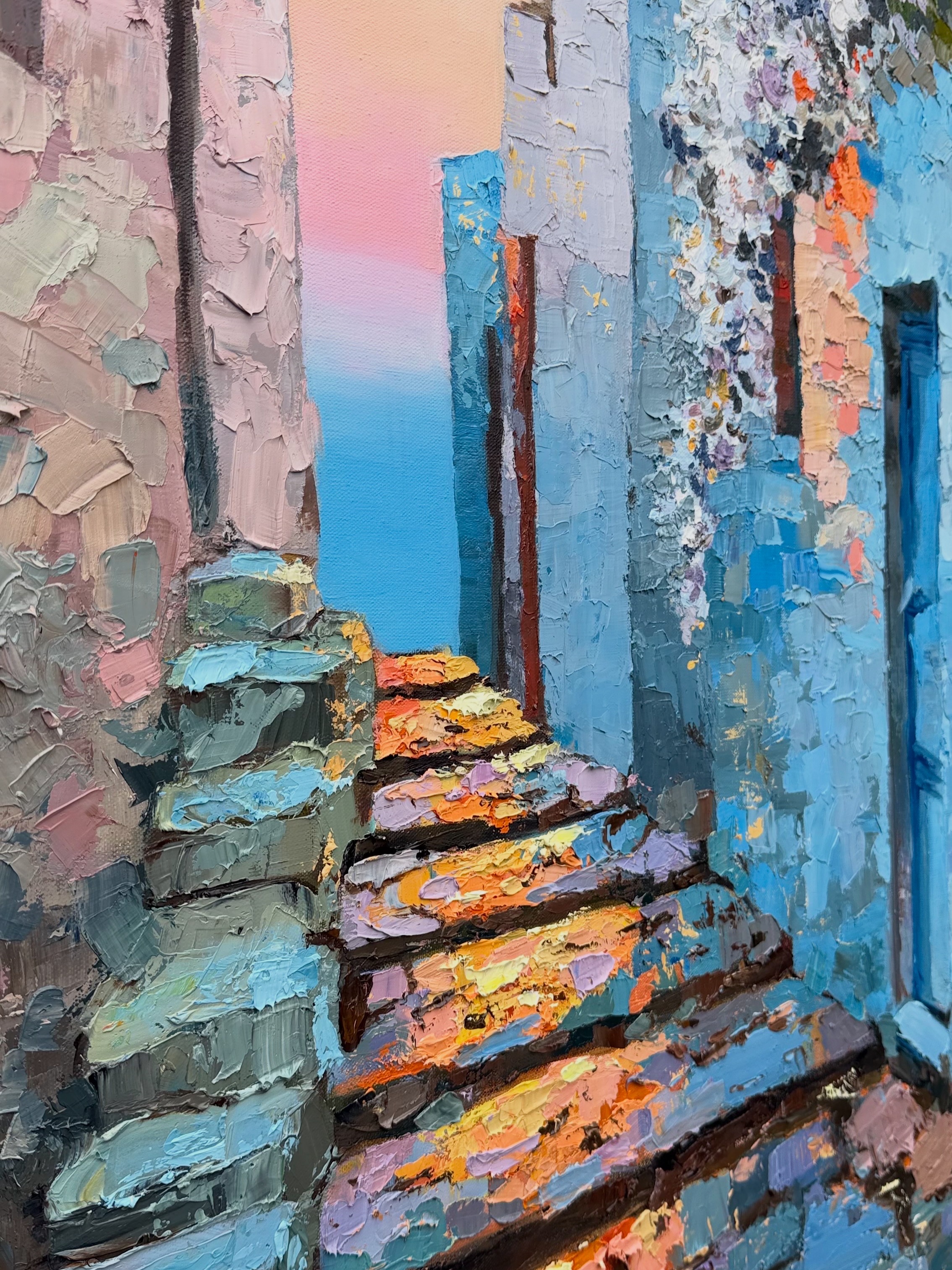 A richly textured stone stairway between blue walls